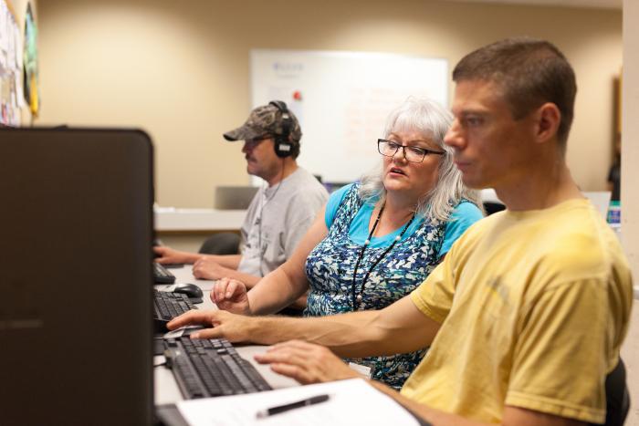 Adult learners work in computer lab